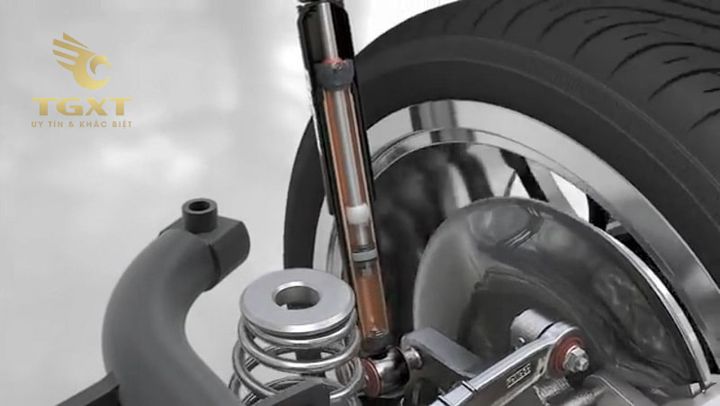 Hình ảnh phân biệt giảm xóc trước và sau của xe tải với các chú thích rõ ràng.